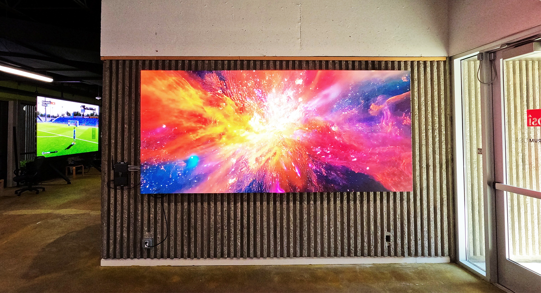 LED display showcasing colorful digital art in an indoor showroom